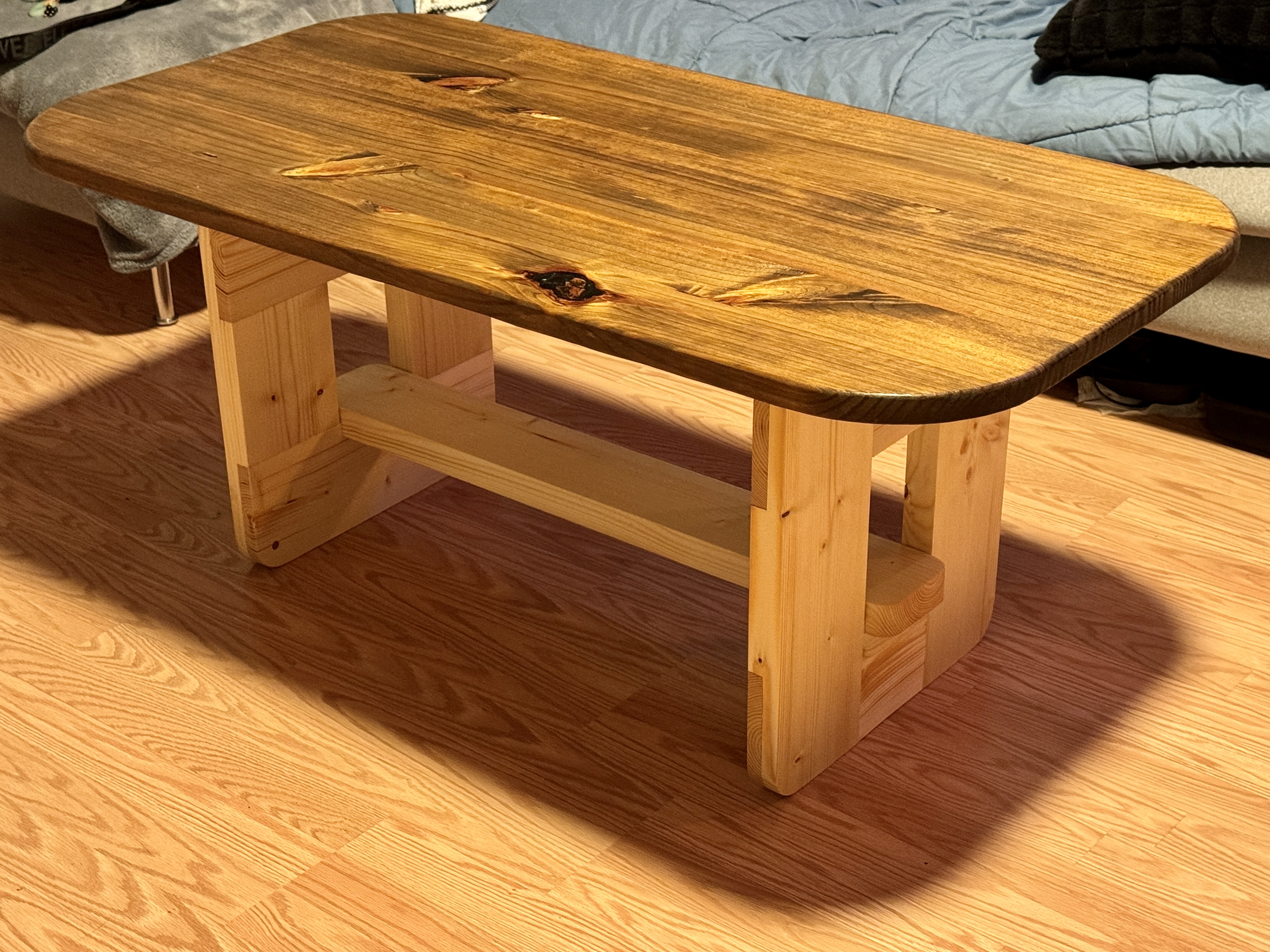 Custom coffee table with walnut-stained top and natural pine base